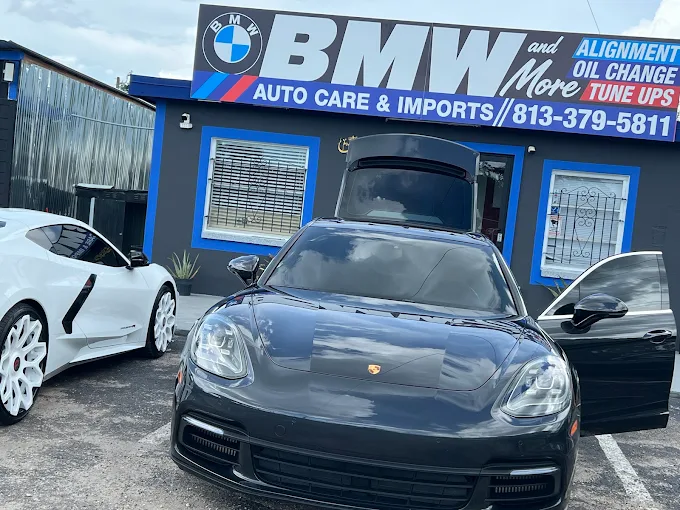 A black Porsche Panamera parked outside the BMW and More storefront, highlighting professional auto repairs in Largo.