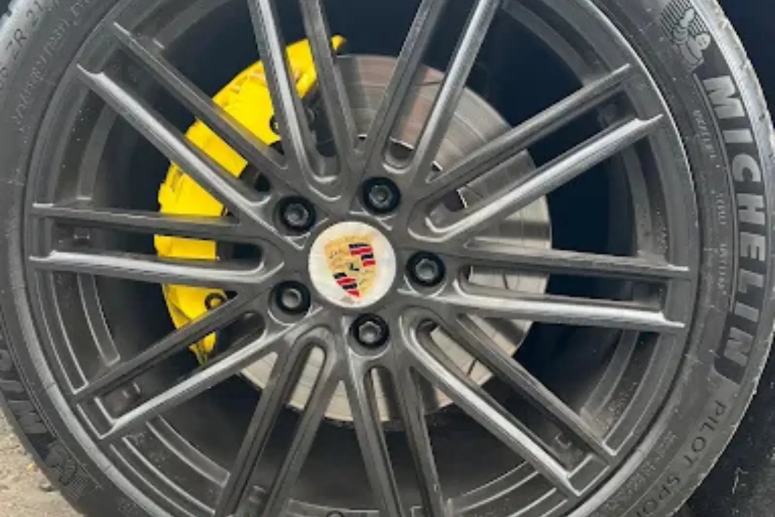 Specialized tire care on a Porsche wheel with yellow brake calipers to optimize the vehicle's performance on most modern European vehicles.