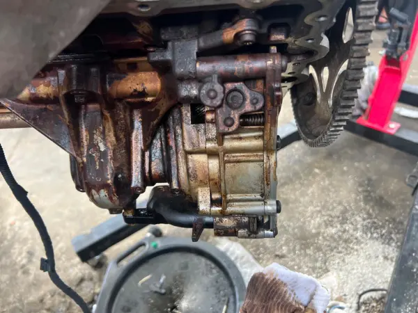 Inspecting an engine flywheel and oil assembly for trusted transmission repair of shifting problems at BMW and More Auto Care LLC.